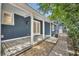 Covered front porch and brick walkway leading to the entrance of a blue house at 2004 E Marks St, Orlando, FL 32803