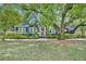 Charming blue home with a lush green lawn and mature trees, exuding curb appeal at 2004 E Marks St, Orlando, FL 32803