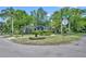 Charming single-story home with lush landscaping, mature trees, and brick walkway to the front door at 2004 E Marks St, Orlando, FL 32803