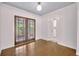Cozy living area featuring hardwood floors, access to the backyard, and a light, airy ambiance at 2004 E Marks St, Orlando, FL 32803