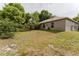 Large backyard featuring a patio door and view of the side and back of the home at 2025 Claremont Dr, Deltona, FL 32725