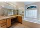 Large bathroom with dual sinks, vanity, garden tub, and separate shower stall at 2025 Claremont Dr, Deltona, FL 32725