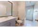 Cozy bathroom featuring a classic toilet and sink vanity next to an exterior door at 2025 Claremont Dr, Deltona, FL 32725