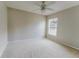 Simple bedroom with neutral carpeting, a ceiling fan, and a window at 2025 Claremont Dr, Deltona, FL 32725