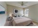 A neutral bedroom features a queen bed, ceiling fan, and modern lamps on mirrored nightstands at 2025 Claremont Dr, Deltona, FL 32725