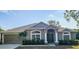 Beautiful single-story home with an attached two-car garage and a neatly landscaped front yard at 2025 Claremont Dr, Deltona, FL 32725