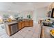Bright kitchen with wooden cabinets, stainless steel appliances, and tile floors at 2025 Claremont Dr, Deltona, FL 32725
