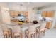Bright kitchen with granite countertops, stainless steel appliances, breakfast bar with seating for four and wooden cabinets at 2025 Claremont Dr, Deltona, FL 32725