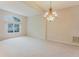 Spacious living room with high ceilings, large window, and carpet flooring at 2025 Claremont Dr, Deltona, FL 32725