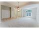 Spacious living room featuring neutral colors, large arched doorways, and a chandelier at 2025 Claremont Dr, Deltona, FL 32725