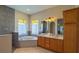 Bright bathroom featuring a bathtub, shower, double sink, and light-filtering window coverings at 20951 County Road 561, Clermont, FL 34715