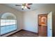 Cozy bedroom with wood flooring, a ceiling fan, and a door opening to the next room at 20951 County Road 561, Clermont, FL 34715