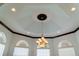 Elegant dining room features a decorative tray ceiling, recessed lighting, and arched windows at 20951 County Road 561, Clermont, FL 34715