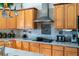 Close up of the kitchen featuring stainless appliances, granite countertop, and maple cabinetry at 20951 County Road 561, Clermont, FL 34715