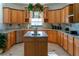 Lovely kitchen with maple cabinets, granite countertops, and a central island sink at 20951 County Road 561, Clermont, FL 34715