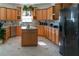 Spacious kitchen includes wooden cabinets, granite countertops, stainless steel appliances, and tiled floors at 20951 County Road 561, Clermont, FL 34715