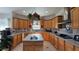 Bright kitchen boasts custom cabinetry, granite countertops, an island sink, and tiled flooring at 20951 County Road 561, Clermont, FL 34715