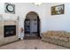 Cozy living room with a fireplace, comfortable seating, and an archway entrance at 20951 County Road 561, Clermont, FL 34715