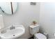 Charming powder room with a decorative sink, toilet, and flower decor at 20951 County Road 561, Clermont, FL 34715