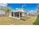Spacious backyard featuring a screened lanai, offering a private outdoor living space at 2381 Pinebrook Ct, Oviedo, FL 32766