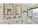 Bathroom features double sinks, black fixtures, and a glass shower with white subway tile at 2381 Pinebrook Ct, Oviedo, FL 32766