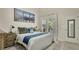 Bright bedroom features a comfortable bed, stylish decor, and sliding glass doors to the outdoor space at 2381 Pinebrook Ct, Oviedo, FL 32766