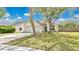 Charming one-story home features a well-maintained lawn, two-car garage and mature shade trees at 2381 Pinebrook Ct, Oviedo, FL 32766