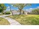 Beautiful single-story residence displaying a spacious front yard and mature trees at 2381 Pinebrook Ct, Oviedo, FL 32766