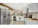 Modern eat-in kitchen features stainless steel appliances, white cabinetry, and marble countertops at 2381 Pinebrook Ct, Oviedo, FL 32766