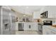 Bright kitchen featuring stainless steel appliances, white cabinetry, and marble countertops at 2381 Pinebrook Ct, Oviedo, FL 32766