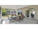 This screened patio is set up for outdoor dining and relaxation with views of the lawn at 2381 Pinebrook Ct, Oviedo, FL 32766