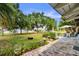 Picturesque backyard view featuring lush landscaping, a fire pit, and outdoor dining area with patio at 2519 Gabriel Rd, Fort Meade, FL 33841
