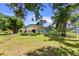 Manicured backyard featuring lush lawn and mature trees, perfect for outdoor activities at 2519 Gabriel Rd, Fort Meade, FL 33841