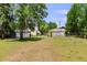 Large backyard with green grass and multiple buildings with lattice at 2519 Gabriel Rd, Fort Meade, FL 33841