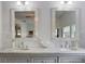 Elegant bathroom featuring double sinks with marble countertop and decorative framed mirrors at 2519 Gabriel Rd, Fort Meade, FL 33841