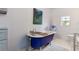 Charming bathroom featuring a blue clawfoot tub and a window for natural light at 2519 Gabriel Rd, Fort Meade, FL 33841