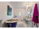 Full bathroom featuring a blue clawfoot tub, a glass shelved vanity and natural light at 2519 Gabriel Rd, Fort Meade, FL 33841