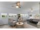 Bright, spacious bedroom featuring light gray armchairs, neutral decor, and three large windows at 2519 Gabriel Rd, Fort Meade, FL 33841