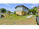Side view of a home with green grass, lush landscaping, and a stone pathway at 2519 Gabriel Rd, Fort Meade, FL 33841