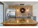 Stylish kitchen featuring a stainless steel refrigerator, granite countertops, and a decorative fall wreath at 2519 Gabriel Rd, Fort Meade, FL 33841