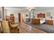 Spacious main bedroom features wood floors, antique furnishings, and attached bathroom and office areas at 2519 Gabriel Rd, Fort Meade, FL 33841