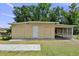 Exterior shot of shed with neutral paint and a covered carport at 2519 Gabriel Rd, Fort Meade, FL 33841