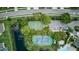 Aerial view showcasing the community's basketball and tennis courts, pond, and adjacent parking area at 2626 Greenwillow Dr, Orlando, FL 32825