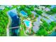 This aerial shows the pool, tennis courts, and lake of a vibrant, amenity-rich community at 2626 Greenwillow Dr, Orlando, FL 32825