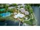Overhead view of community pool, tennis court, and lush landscaping, surrounded by serene pond at 2626 Greenwillow Dr, Orlando, FL 32825