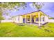 Spacious backyard featuring a covered patio, well-maintained lawn and landscaped garden beds at 2626 Greenwillow Dr, Orlando, FL 32825
