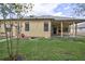 Well-maintained backyard with lush lawn, manicured landscaping, and a covered patio, ideal for outdoor relaxation and entertainment at 2626 Greenwillow Dr, Orlando, FL 32825