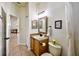 Bathroom with wood vanity, framed mirror, and decorative lighting fixtures at 2626 Greenwillow Dr, Orlando, FL 32825