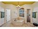 Bright bathroom with an alcove tub, tiled shower, dual vanities, and a chandelier, creating a spa-like atmosphere at 2626 Greenwillow Dr, Orlando, FL 32825