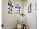 Powder room boasts arched windows, a modern toilet, and decorative accents at 2626 Greenwillow Dr, Orlando, FL 32825